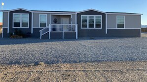 A single-story building with a front porch, a door, and a small window. - 10 acres, for dirtbikes+ near Death Valley, casinos and wineries, Stargazing ect (Pahrump)