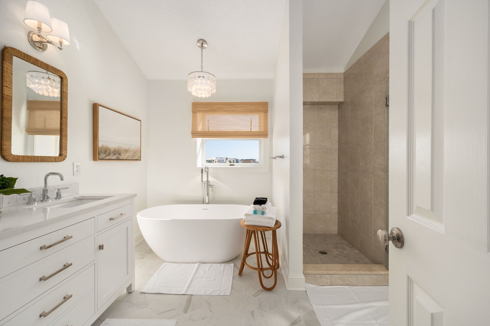 A modern bathroom with a freestanding bathtub, a vanity with a mirror, and a shower area.