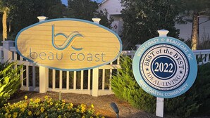 A wooden sign with 'beau coast' and a circular plaque stating 'BEST of the BEST 2022'. - Beautiful Beau Coast Home w/ Pool, Bikes, EV Charger & Dock Access (Beaufort)