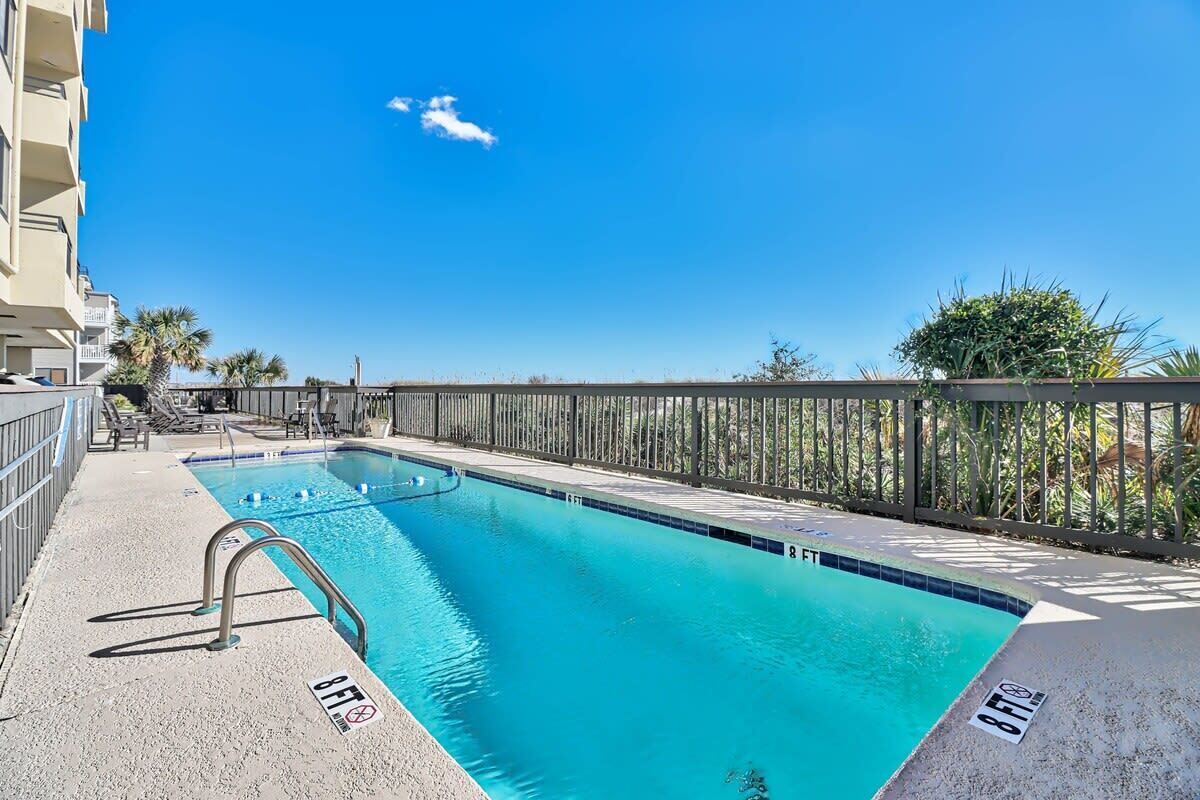 A rectangular swimming pool with a metal ladder and a 8 FT depth marker.