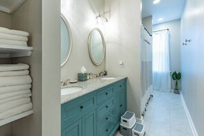 Bathtub, hair dryer, towels, shampoo