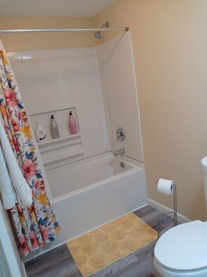 Combined shower/bathtub, towels, soap, toilet paper