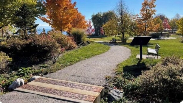 A pathway leading through a park with trees, a bench, and a solar panel. - Cozy 1 bedroom Appartment  minutes away from Ajax Waterfront. (Ajax)