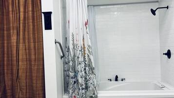 Combined shower/bathtub, towels, soap, shampoo