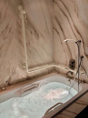 Bathtub, jetted tub, hair dryer, towels