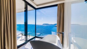 A modern room with large windows offering a view of the sea and distant land. - PureLuxuryExclusiveVillaStateOfTheArtVillaExcellentLocationPrivateBeach (Zaton)