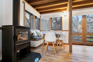 Cozy seating area with a wood-burning stove and a view of the outdoors.