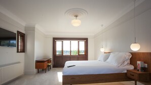 A bedroom with a wooden bed, a desk, and a window with a view. - The Old Mount Manor, Causeway Coast (Coleraine)