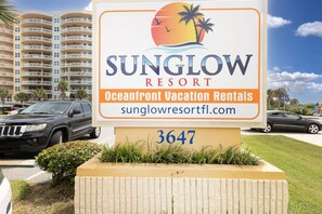 A sign for Sunglow Resort with the address 3647, indicating a vacation rental property.