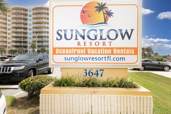 A sign for Sunglow Resort with the address 3647, indicating a vacation rental property.