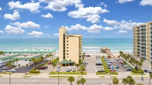 A hotel with a beach view, parking lot, and a pier. - Ocean View Suite w/ Pool, Hot Tub & Beach Access (Daytona Beach Shores)
