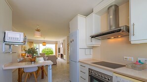 A modern kitchen with a built-in oven, microwave, and dishwasher.