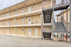 A multi-story hotel with balconies and a central staircase. - Balcony & Boat Slip: Lakefront Unit in Hot Springs (Hot Springs)
