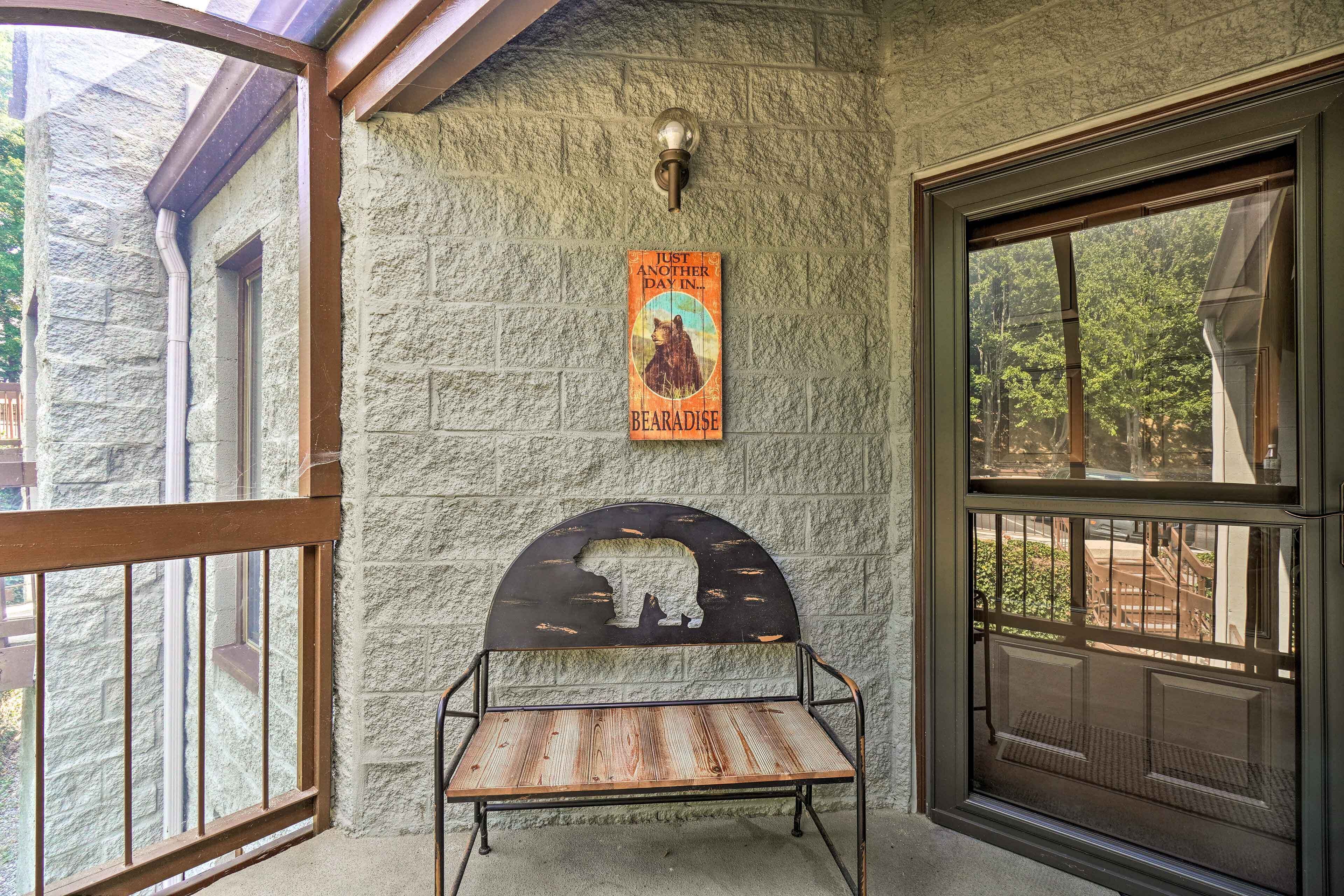 A stone wall with a metal bench and a poster.