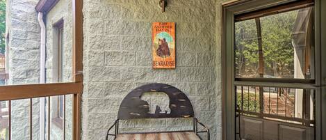 A stone wall with a metal bench and a poster.