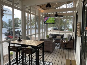 Relax and socialize in this inviting outdoor space with a sofa, table, and chairs, offering stunning views of the surrounding area.