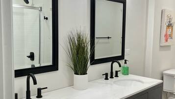 Combined shower/bathtub, towels, soap, toilet paper