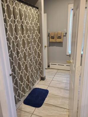 Combined shower/tub, hair dryer, towels, soap