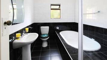 Bathtub, hair dryer, towels, soap