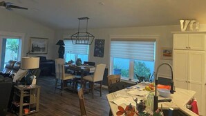 A spacious living area with a dining table, chairs, and a kitchen area with a sink and cabinets. - Stunning Golf Front 3 BR Villa in The Villages (THE VILLAGES)