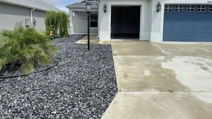 A residential building with a garage, driveway, and landscaping. - Stunning Golf Front 3 BR Villa in The Villages (THE VILLAGES)
