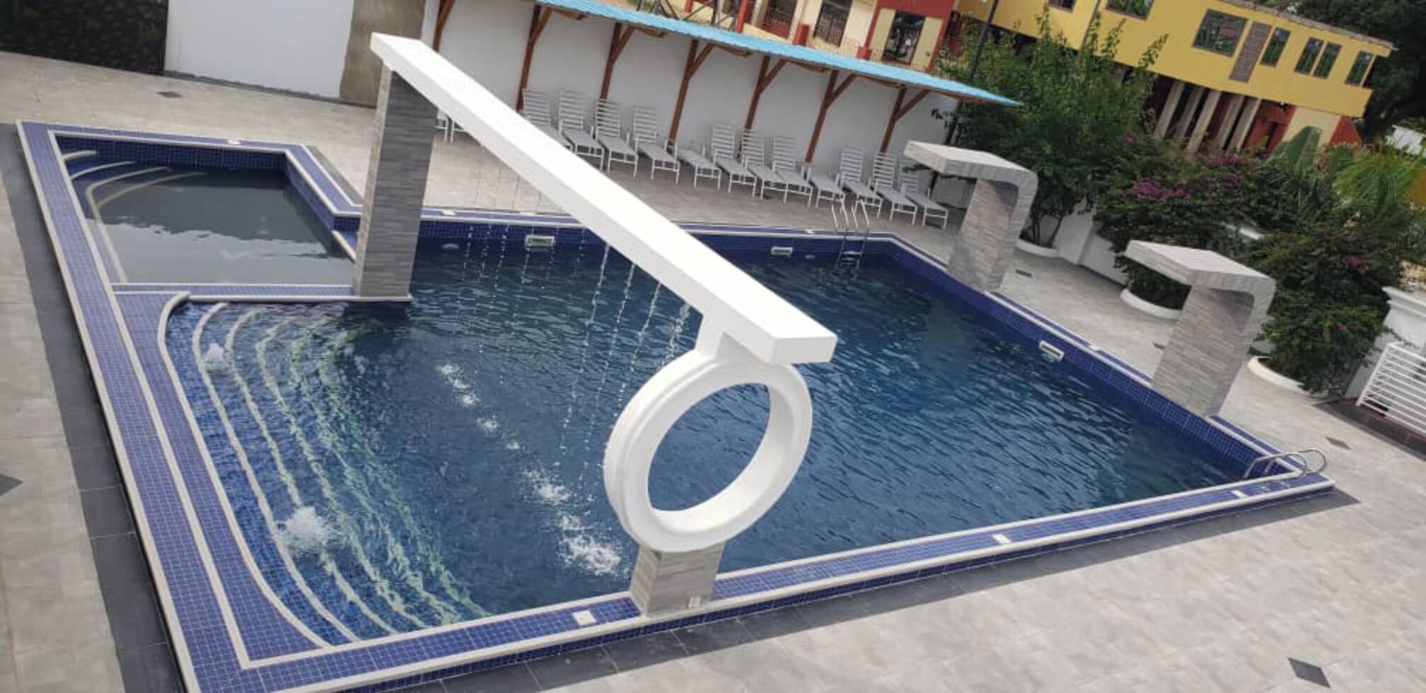A swimming pool with a unique design, including a large male symbol structure in the center.