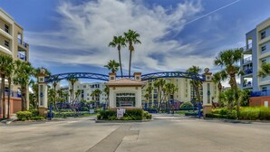 A gated entrance with a sign reading "SALES OFFICE" and "OPEN HOUSE."