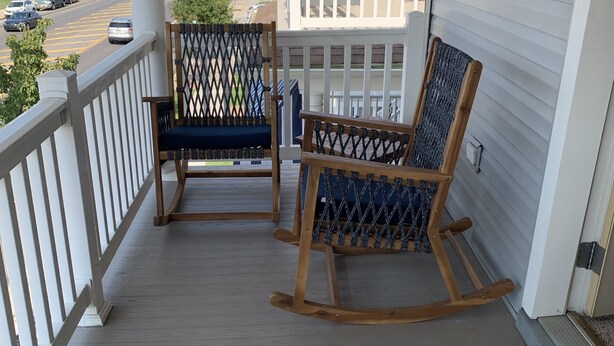 A porch with two rocking chairs and a doormat with a dog and hat design. - Cute Condo in the heart of OCNJ  (Ocean City)