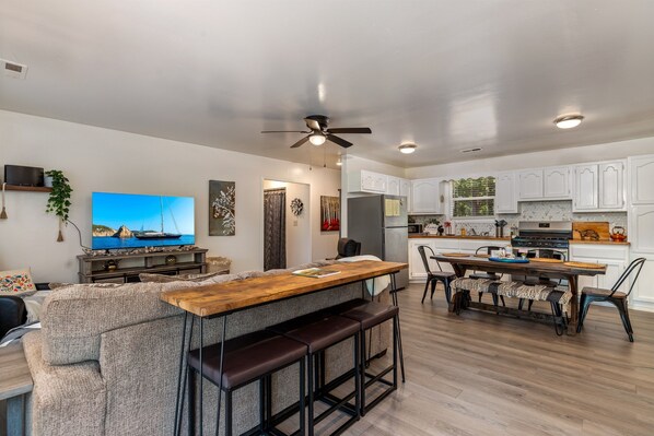 A modern kitchen with white cabinets, a built-in oven, and a refrigerator. - Lake Views & Fall Colors | Cozy Cottage + Kayaks (Jay)