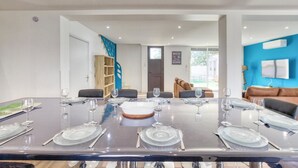 A modern dining area with a large table set for six, surrounded by comfortable seating. - Stunning home in Albi (Albi)