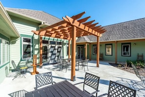 A covered patio area with outdoor seating and a pergola structure.