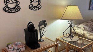 A cozy living room with a coffee table, a side table with a lamp, and decorative wall art. - Professor Rousseau's Manatee Bay (Crystal River)