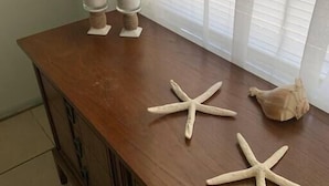A wooden table with two glass containers and two starfish. - Professor Rousseau's Manatee Bay (Crystal River)