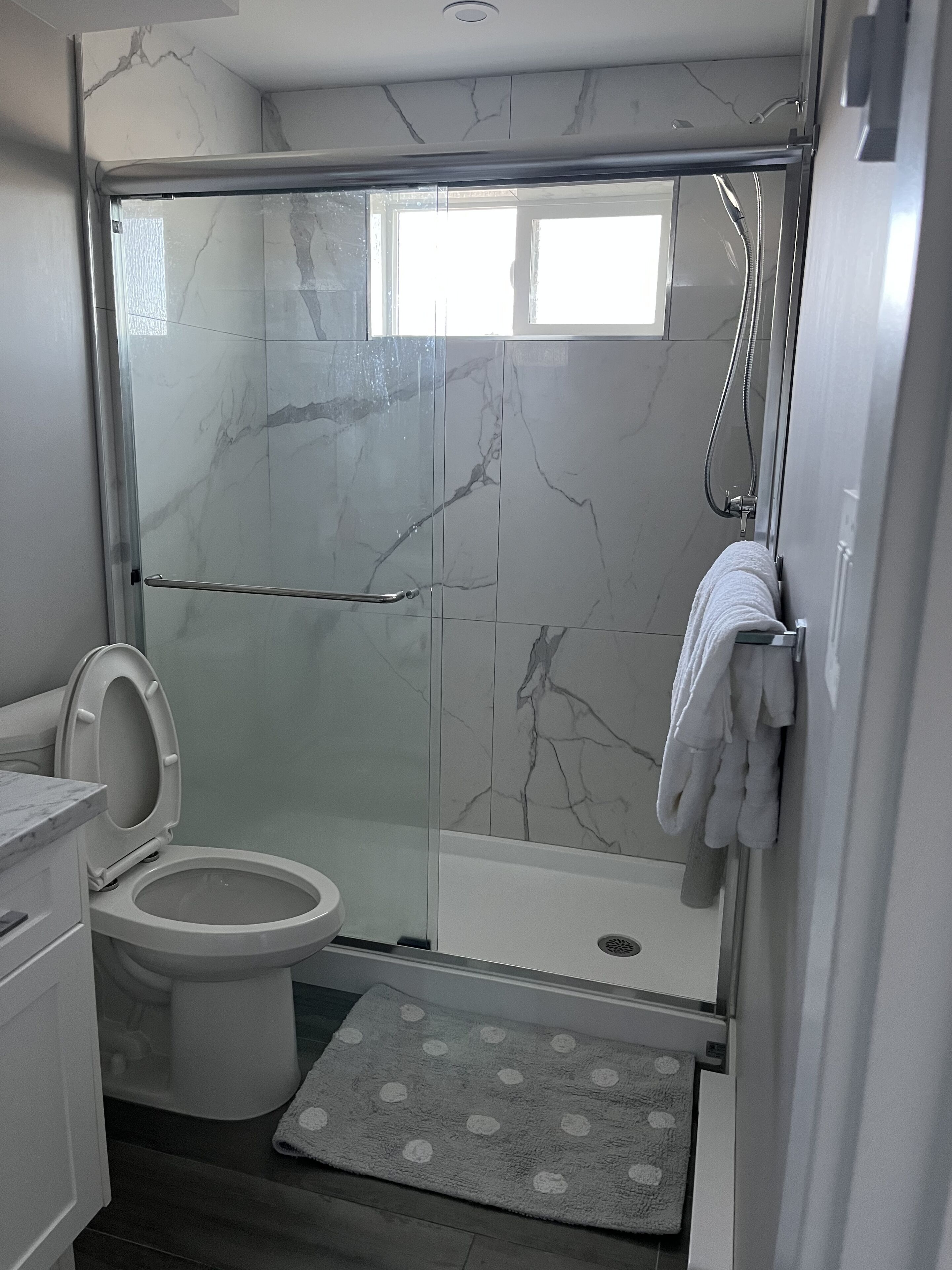 Shower, hair dryer, towels, shampoo