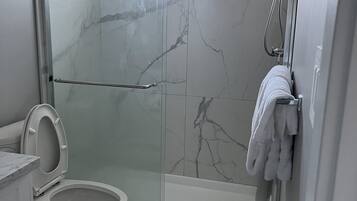 Shower, hair dryer, towels, shampoo