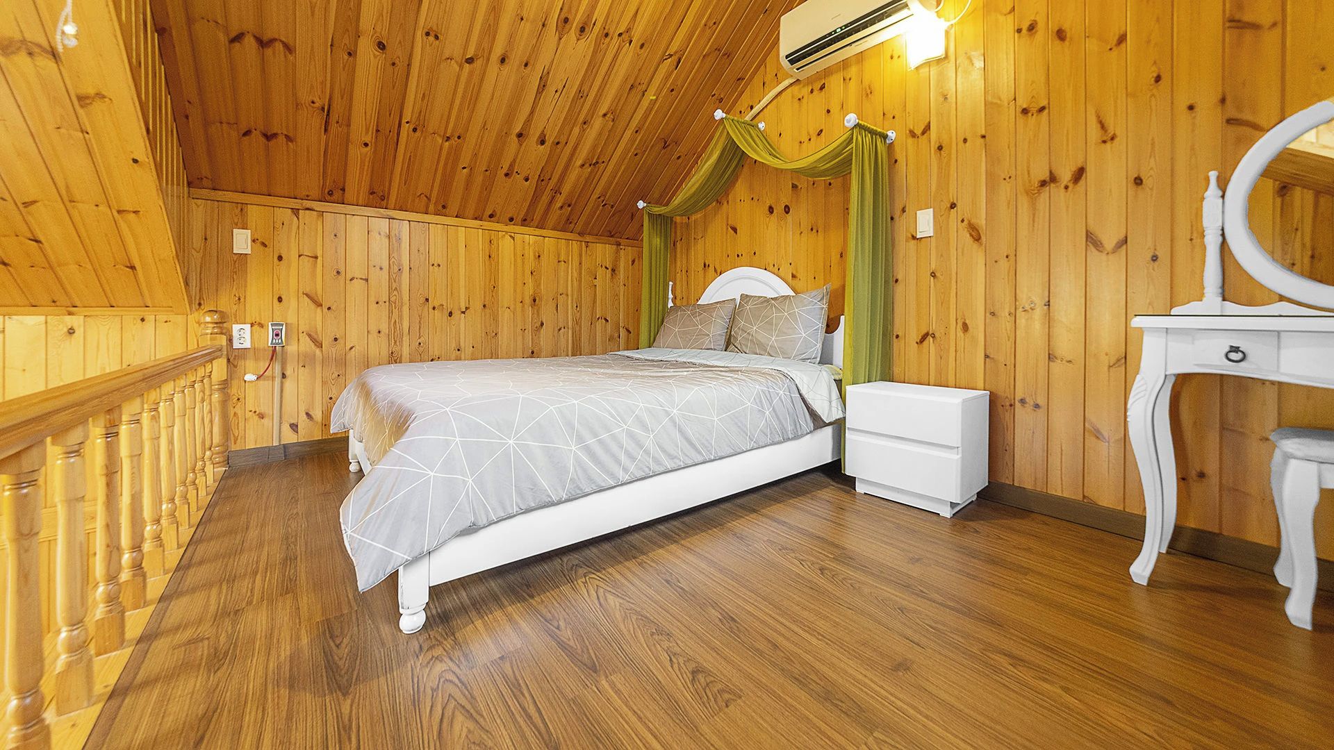 A bedroom with a wooden ceiling, a bed with a canopy, a nightstand, a dresser, and a mirror.