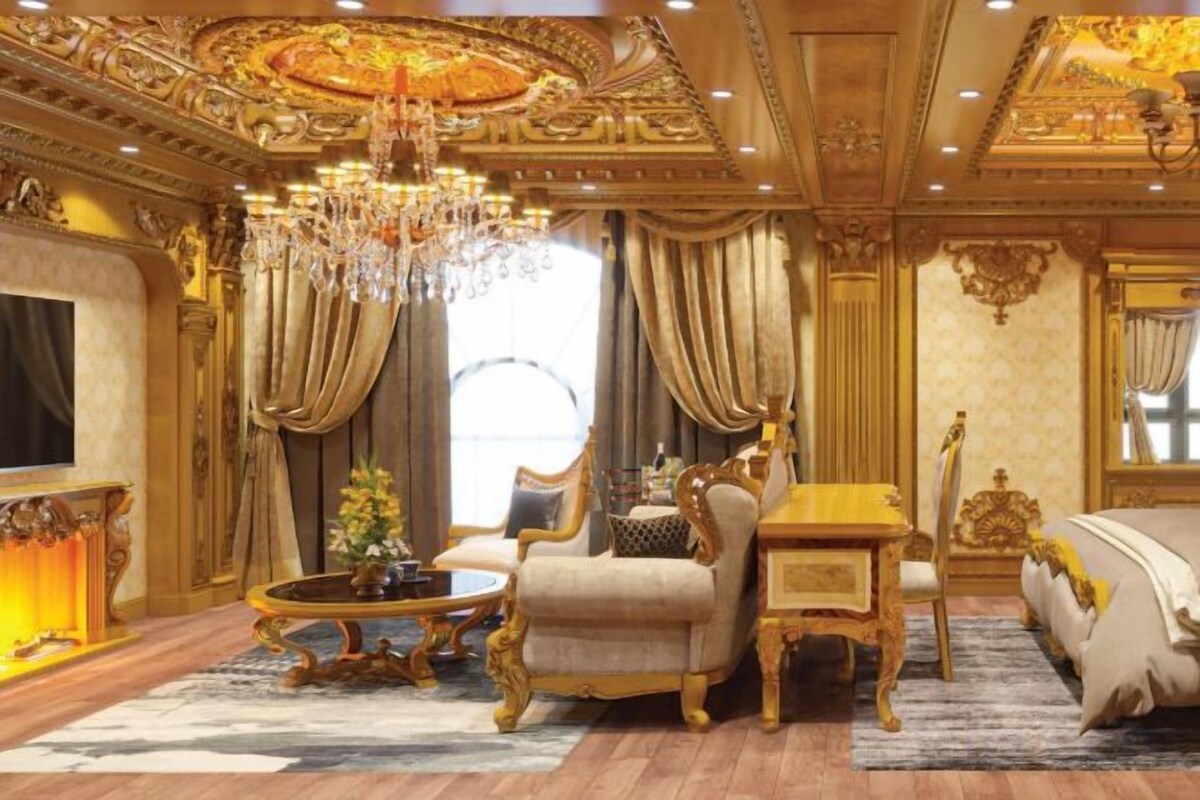 A luxurious room with a chandelier, a sofa, a dining table, and a TV.
