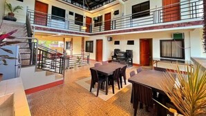 A multi-level hotel with a central atrium, balconies, and a staircase. - Weekdays Hot Spring Resort by Cocotel (Calamba)