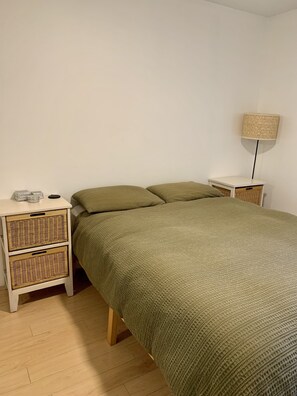 Queen size bed, large balcony window and spacious chest of drawers for guests