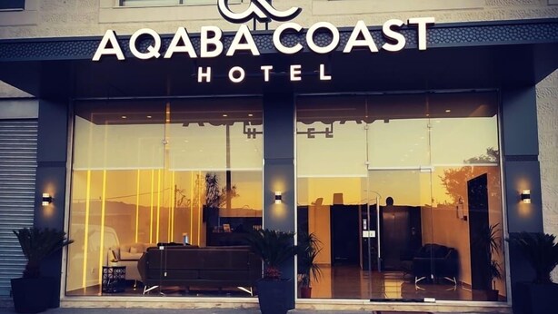The exterior of the Aqaba Coast Hotel with a modern design, featuring large glass windows and a welcoming entrance. - AQABA COAST HOTEL (Aqaba)