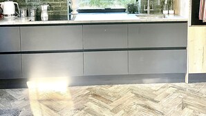 A modern kitchen with a large window, a sink, and wooden cabinets. - Nestled in a grand private estate, near woodlands, easy access London (Kingston upon Thames)