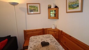 A room with a bed, a wooden headboard, a small cabinet, and two framed pictures on the wall. - Cozy apartment 3-5 pers, pool, near slopes, village center (Arêches-Beaufort)