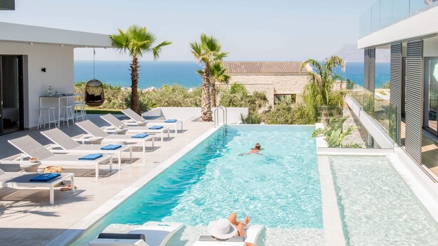 A rooftop pool with lounge chairs and a view of the sea. - Glamorous Villa with Two Swimming Pools and great view (Chania)