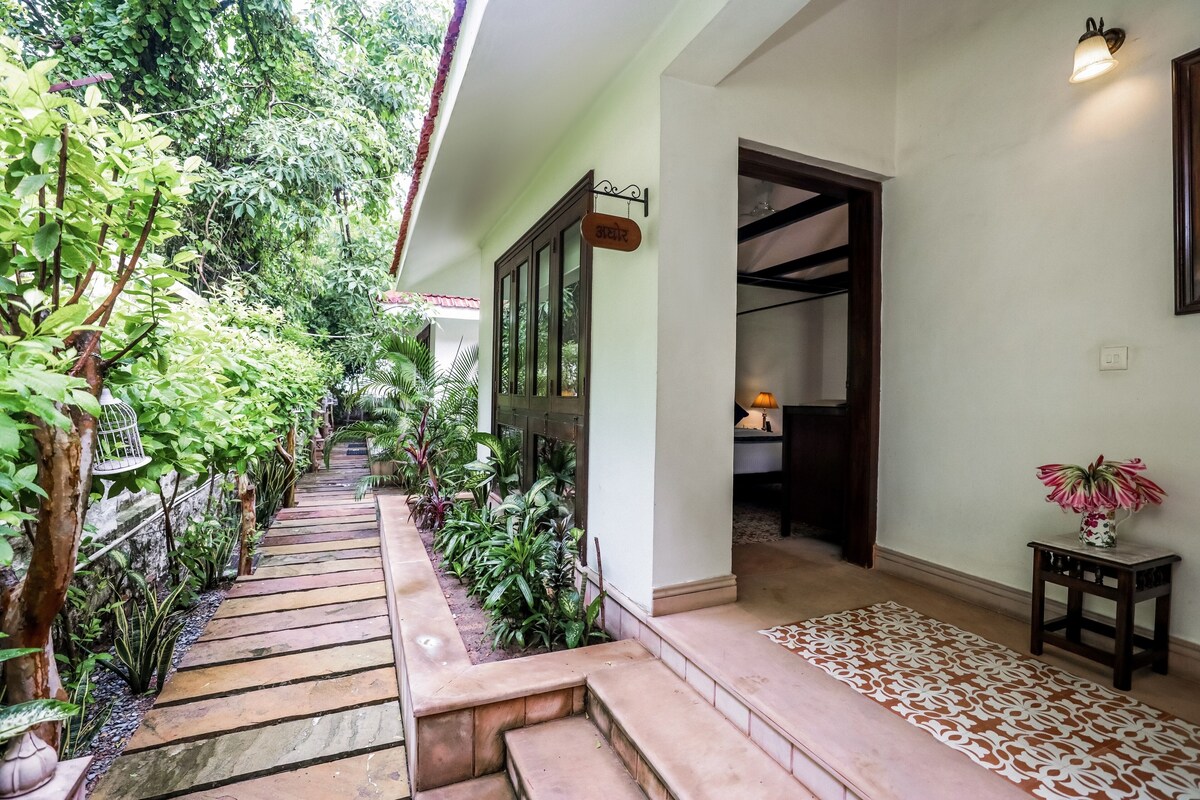 A staircase leading to a room with a view of lush greenery.