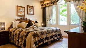 A bedroom with a bed, pillows, a nightstand, a desk, a chair, a ceiling fan, and two windows with curtains. - Low Season rate!
 Cozy 3 house, close to the beach, w/private pool and BBQ (Playa del Carmen)