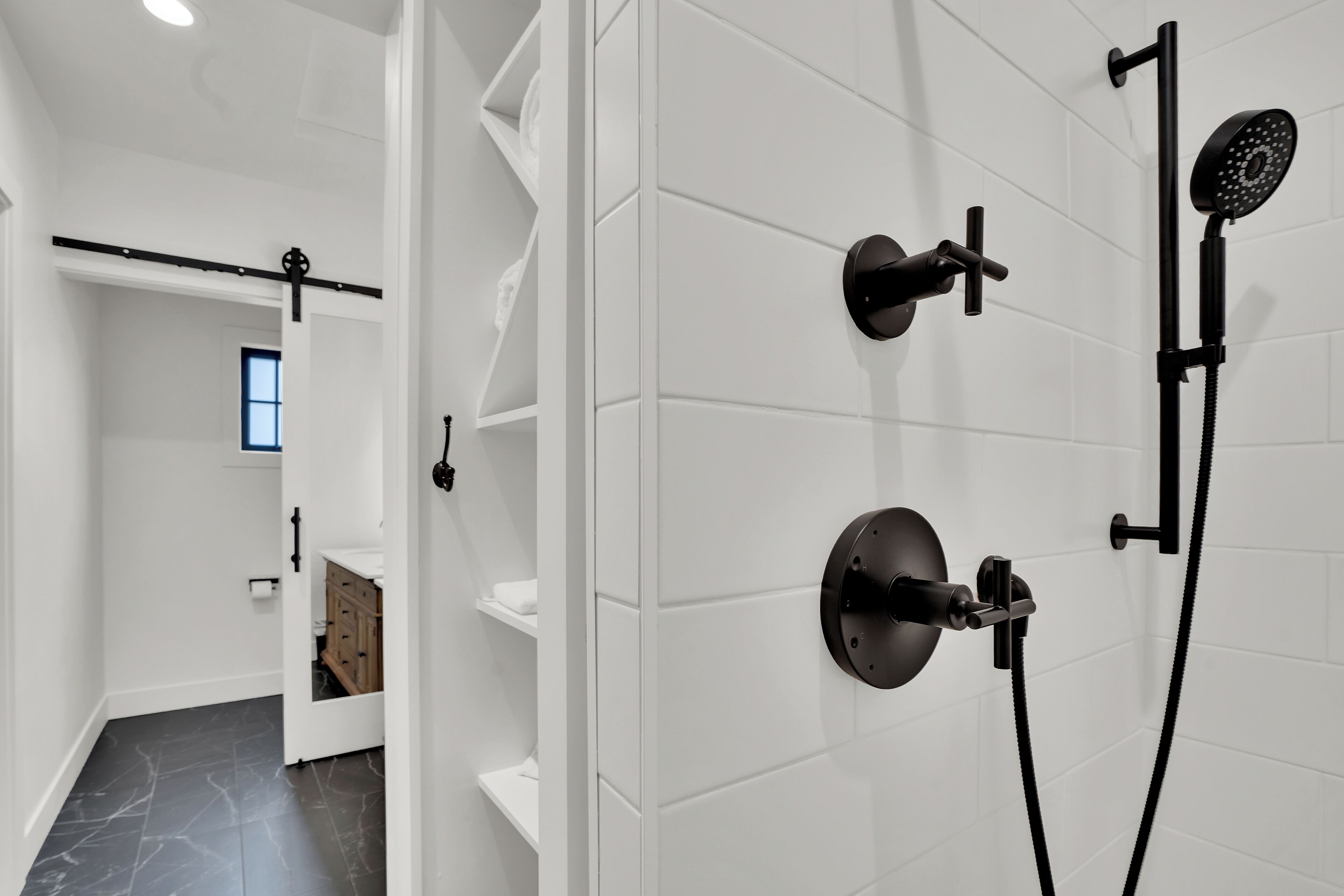 A modern bathroom with a shower, a toilet, and a sink.