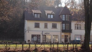 A two-story building with a sign reading "JANY" on the ground floor. - Penzion JANY (Luhacovice)