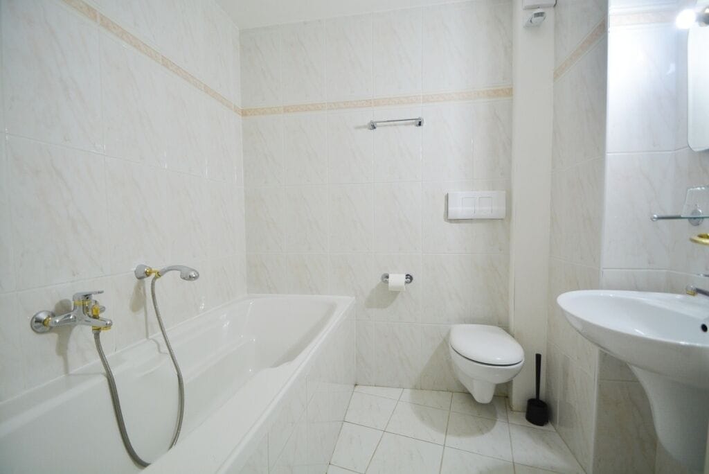 A bathroom with a bathtub, toilet, and sink.
