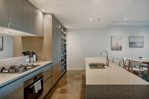 Enjoy cooking in this well-equipped kitchen with a central island, gas stove, and oven.