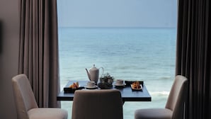 A table with a teapot, cups, and fruit, facing a view of the sea. - MaRadha Colombo (Colombo)